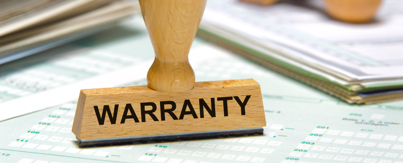 Warranty stamp on stack of F&I paperwork